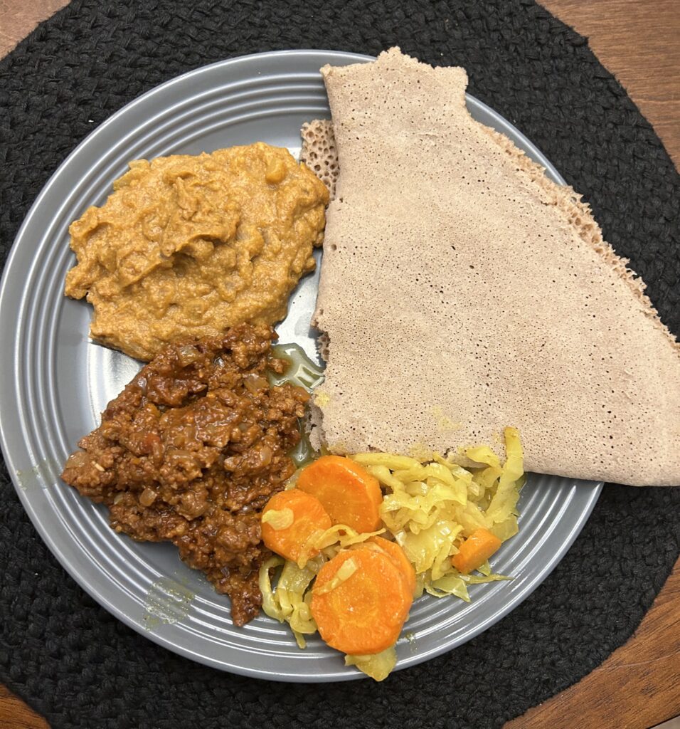 (Injera with akilt wat, vegan sega wat made with gardein ground be’f and shiro wat)