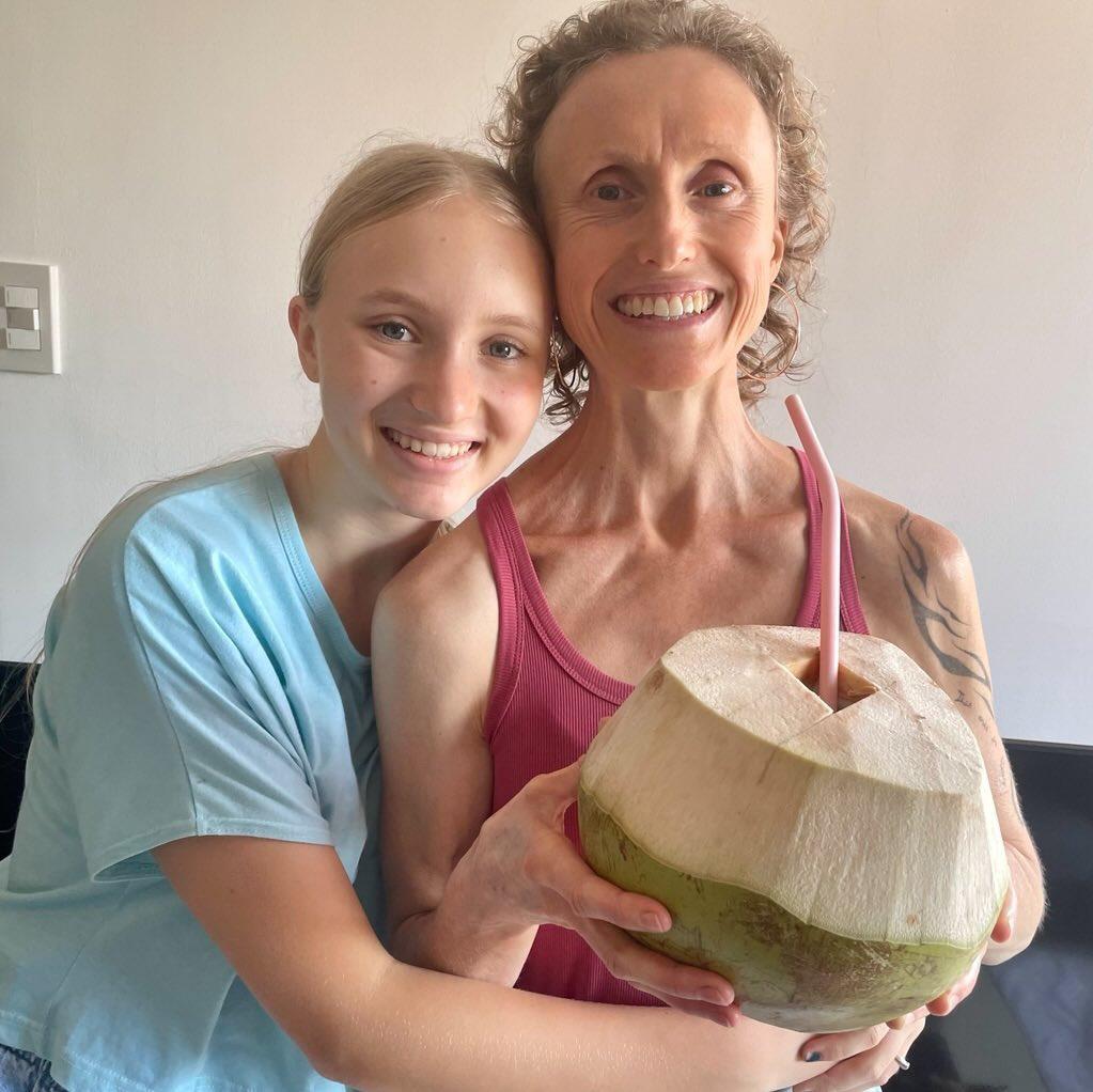 My baby and me enjoying a yummy fresh coconut.: Leanne Hill | Raw Vegan
