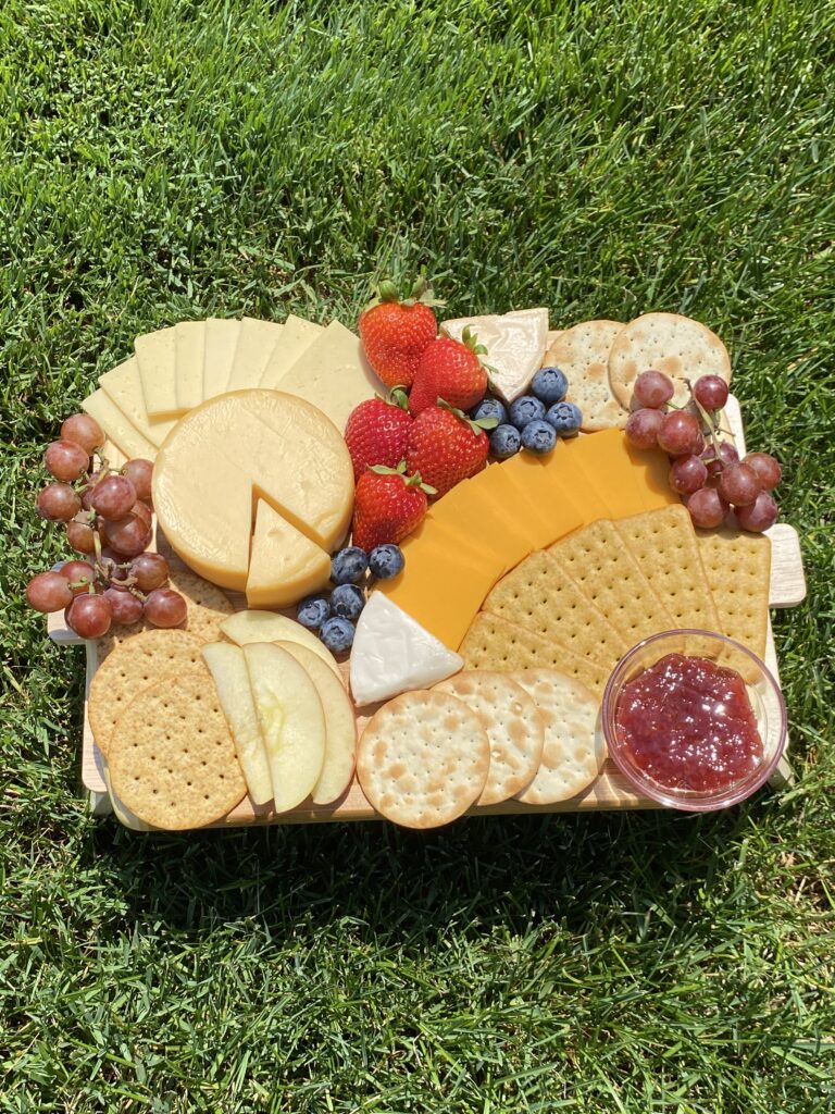 Vegan charcuterie board featuring assorted cheeses by Good Planet Foods, fresh organic fruit and various crackers from Whole Foods, and strawberry fruit spread from St. Dalfour : Alex | Vegan Everything
