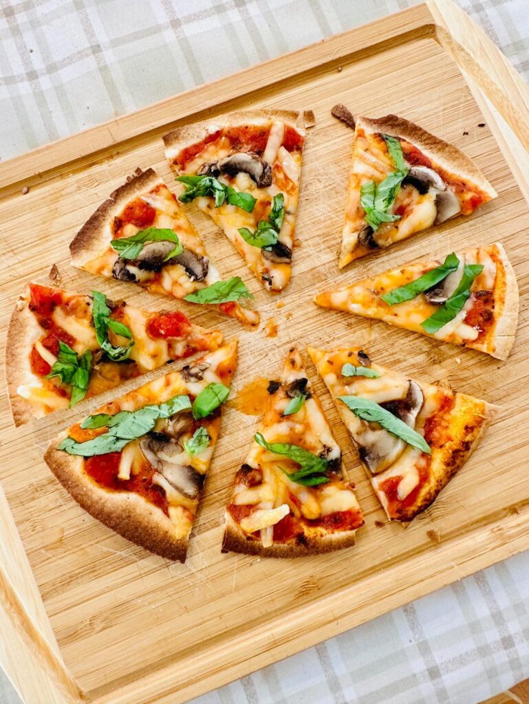 Vegan cheese pizza I made with Violife mozzarella, tomato sauce, mushrooms, and basil: Alex | Vegan Everything