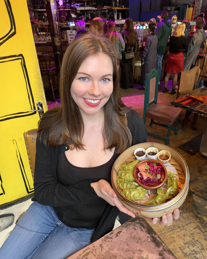 Deanna Troy Travels - Deanna displays vegan dumplings in London, England